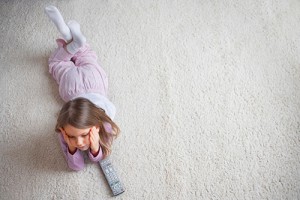 kid laying on the carpet